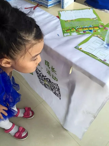 一只蝴蝶飛到小蝸牛的旗子上，小朋友看得入神啦~