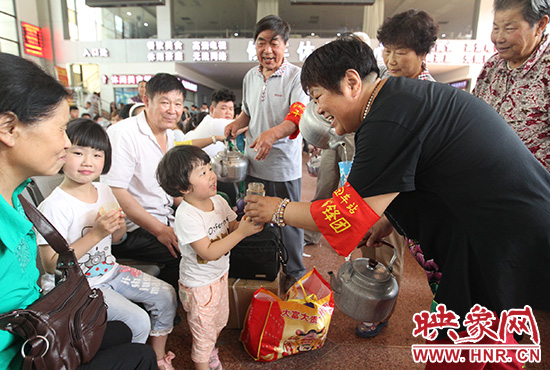 老年雷鋒團”志愿者在候車廳為旅客送水。