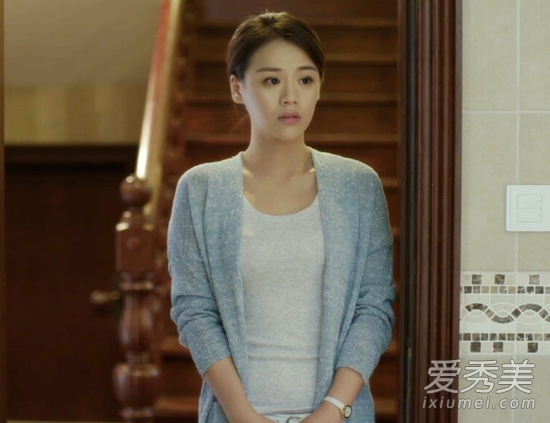 灰色開衫內(nèi)搭圓領(lǐng)的米色T恤，優(yōu)雅知性