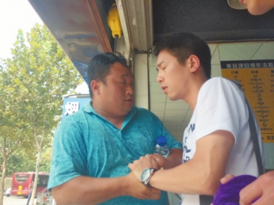 記者正查看照片，突遭藍衣男強搶手機。