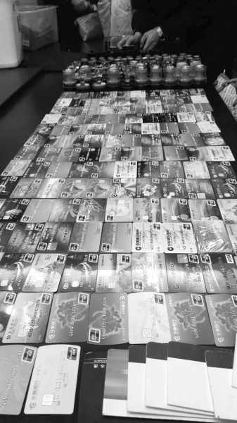 警方在行動(dòng)中繳獲的地下錢莊持有的銀行卡和手機(jī)、U盾等作案工具。