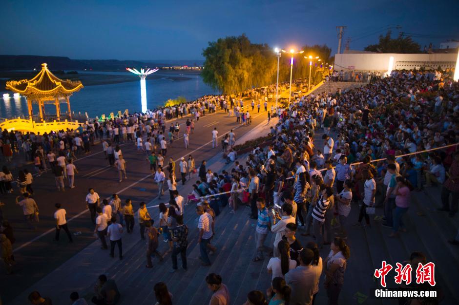 數(shù)萬民眾前來黃河邊觀看河燈。 張?jiān)?攝
